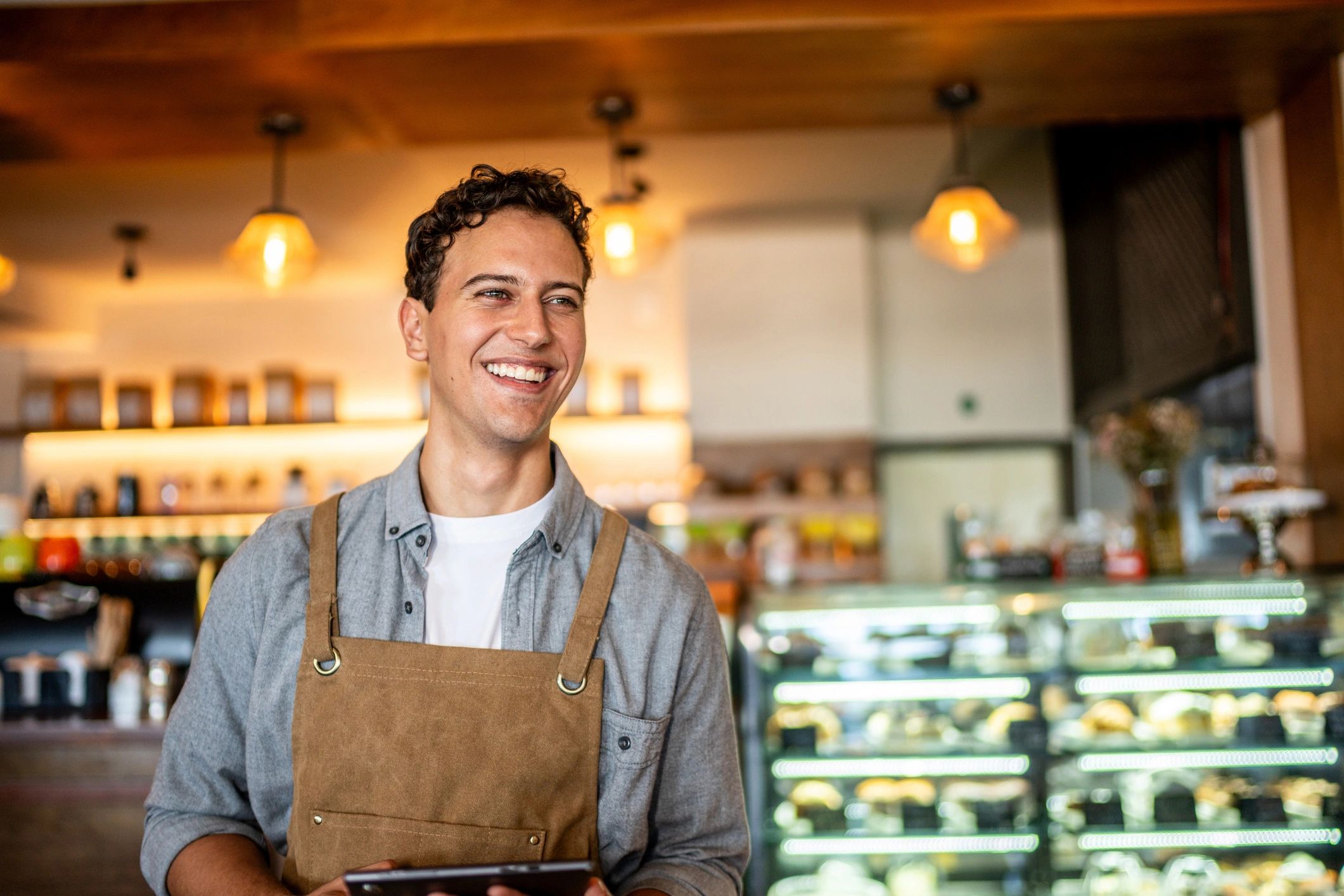Restaurant staff using a tablet in a cafe